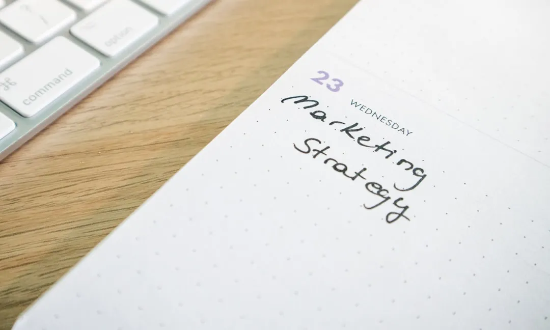 a notepad with the words marketing strategy written on it